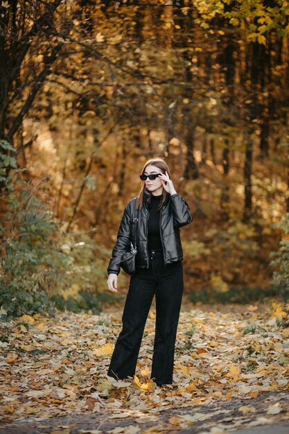 Lovely couple posing in autumn forest, lovers walking in park