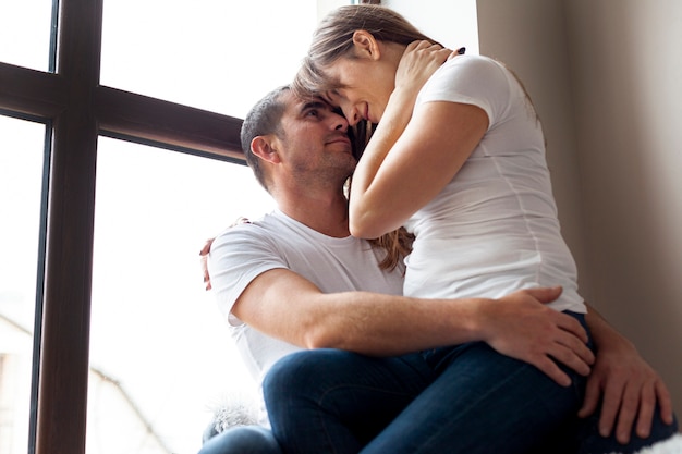 Lovely couple sitting next to a window