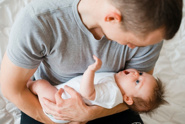 Free photo lovely dad holding cute baby