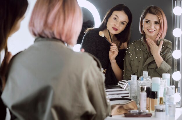 Lovely females looking in the mirror