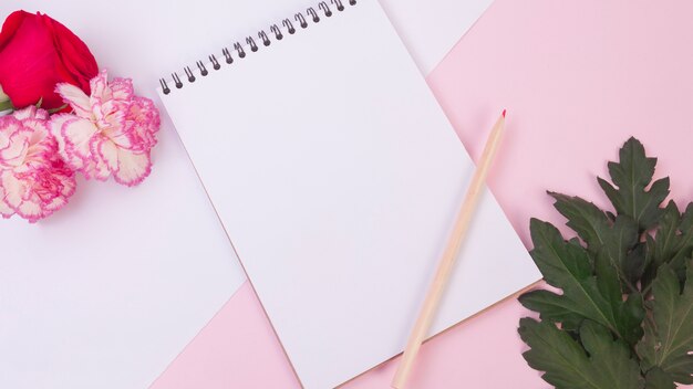 Lovely flowers concept with modern notebook