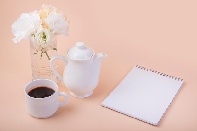 Lovely flowers concept with notebook and coffee