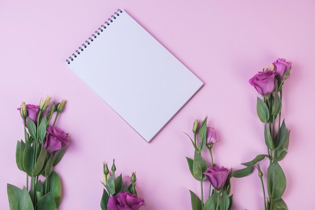 Free photo lovely flowers concept with notebook