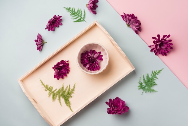 Lovely flowers concept with wooden tray