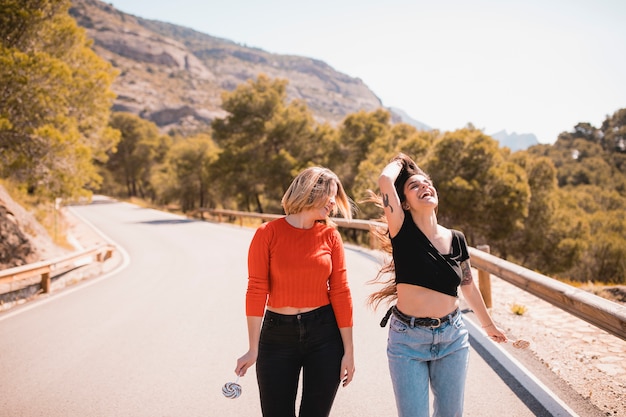 Lovely friends walking along road