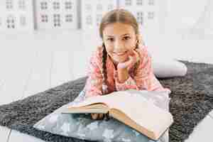 Free photo lovely happy girl posing with a book