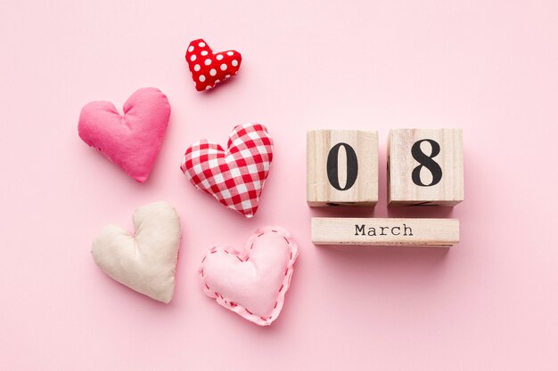 Прекрасные сердца на розовом фоне с 8 марта надписи