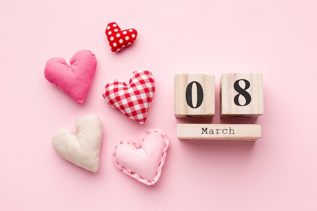 Lovely hearts on pink background with 8 march lettering