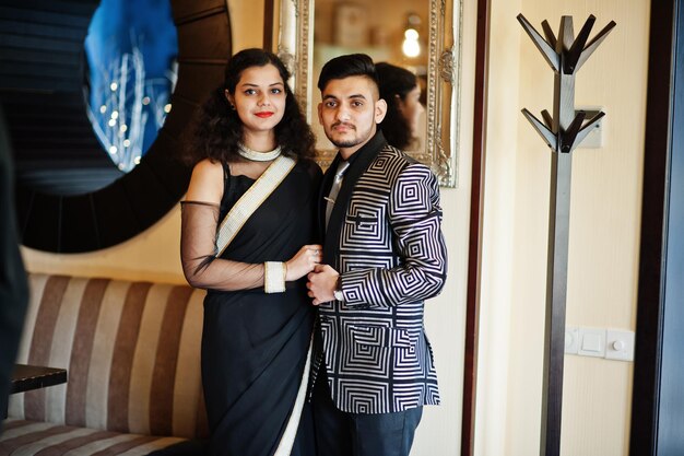 Lovely indian couple in love wear at saree and elegant suit posed on restaurant