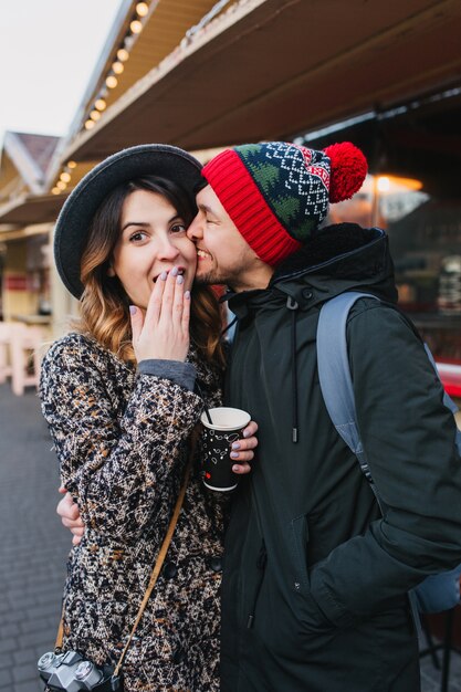 Lovely joyful couple chilling, hugging on street in christmas time. True love emotions, having fun, enjoying togetherness, dating, romantic relationship, happines together.