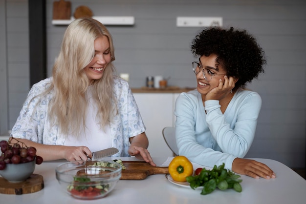 Free photo lovely lesbian couple spending time together in the kitchen