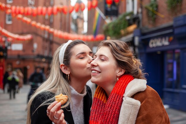 Lovely lesbian women kissing outdoors