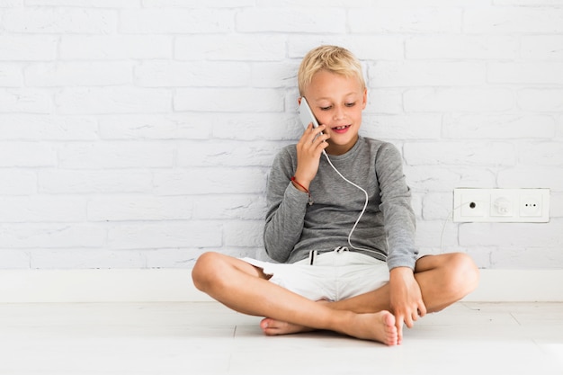 Lovely little boy using his smartphone