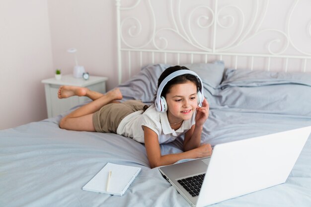 Lovely little girl using her laptop