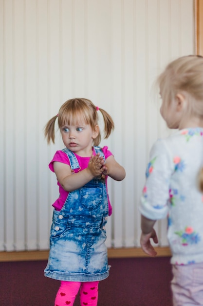 Free photo lovely little girls standing in room