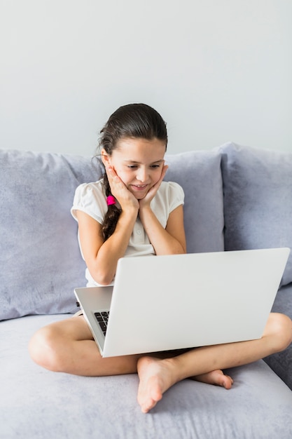 Lovely little girls using her laptop