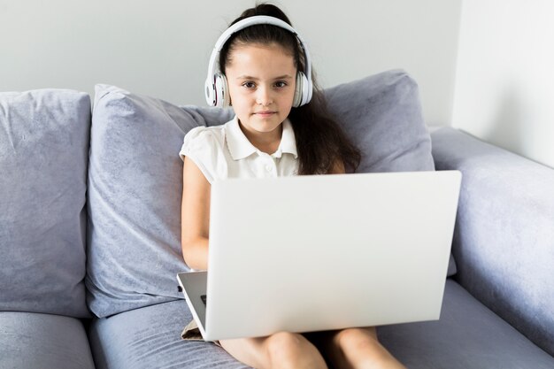 Lovely little girls using her laptop