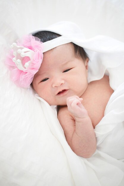 Lovely newborn Asian baby sleeping on furry cloth