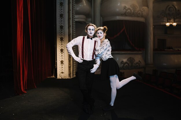Lovely portrait of female and male mime artist standing on stage