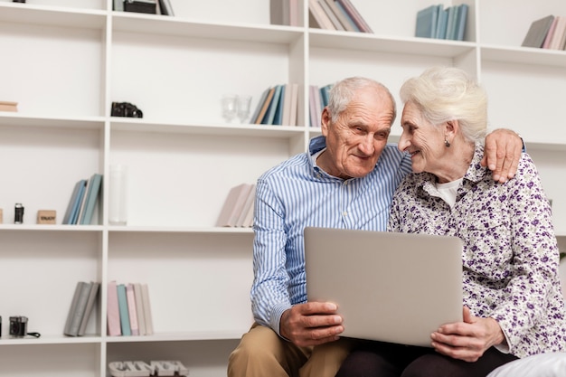 Lovely senior couple holding a laptop