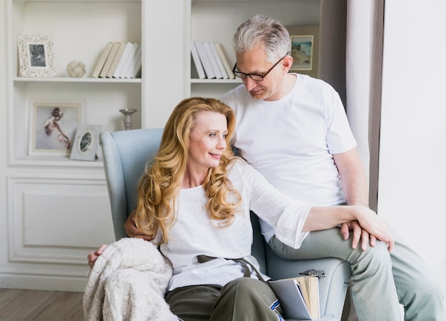 Lovely senior man and woman on armchair