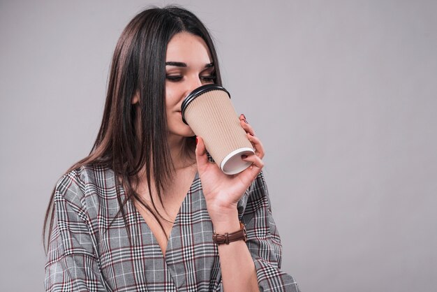 Lovely woman drinking hot beverage