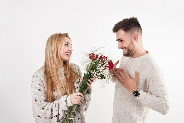 Lovely woman giving flowers to man