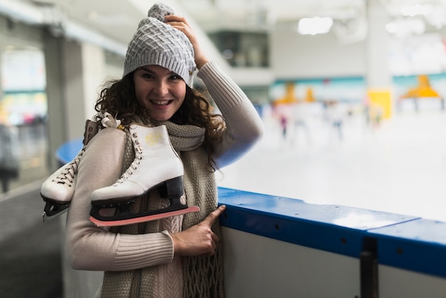 Free photo lovely woman posing near skating rink