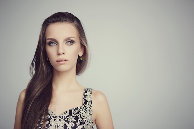 Lovely woman posing with elegant black dress, fashion concept