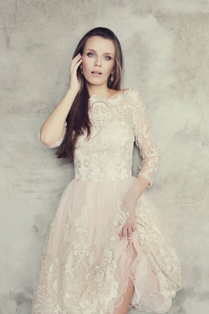 Lovely woman posing with elegant white dress