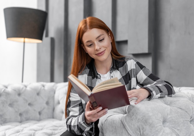 Free photo lovely woman reading book indoors