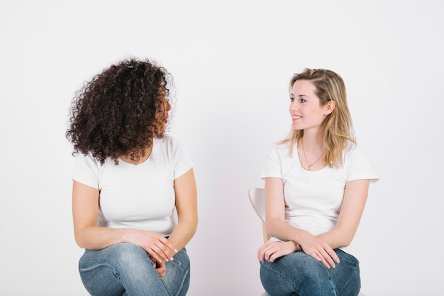 Lovely women on chairs speaking