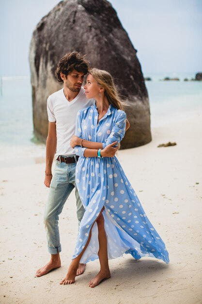 Lovely young stylish hipster couple in love on tropical beach during vacation