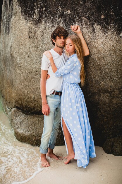 Lovely young stylish hipster couple in love on tropical beach during vacation