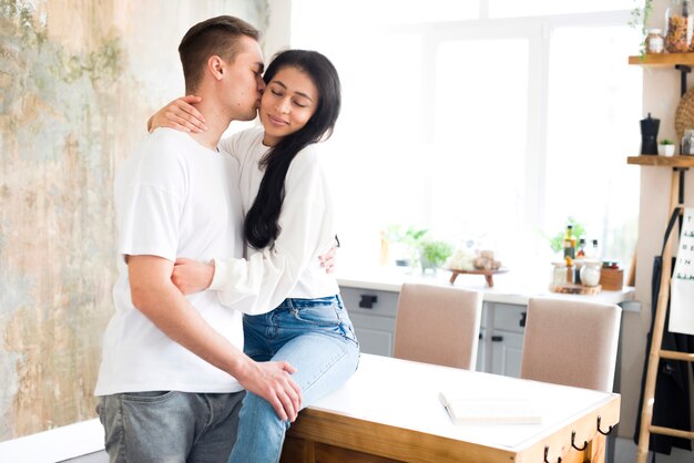 Lover kissing on cheek Hispanic beloved young woman