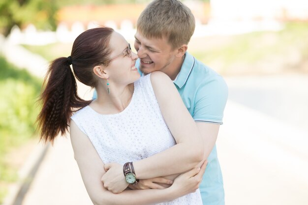 Lovers hugging and laughing on the street