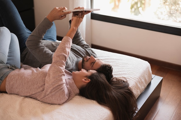 Free photo lovers laying in bed medium shot