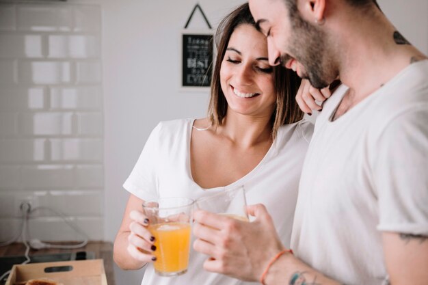 Loving couple drinking juice