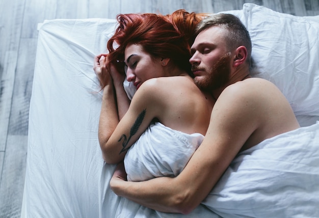 Loving couple embracing in bed