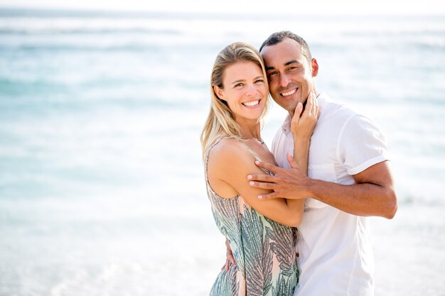 Loving Couple Embracing on Summer Sea Beach