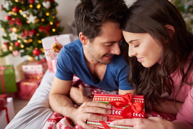 Loving couple lying in bed during the Christmas