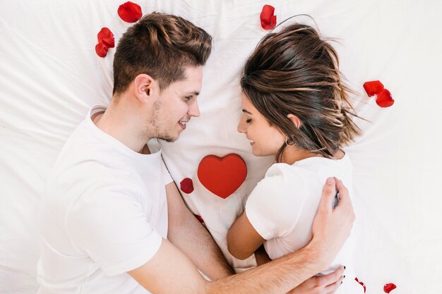 Loving couple lying on bed