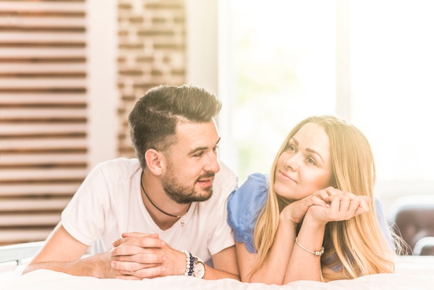 Loving couple lying on bed