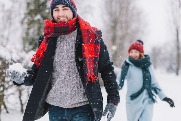 Free photo loving couple playing snowballs