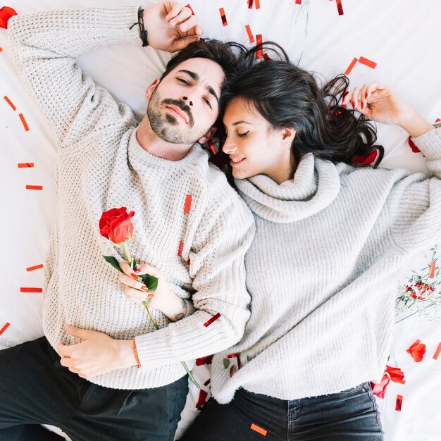 Loving couple resting on confetti