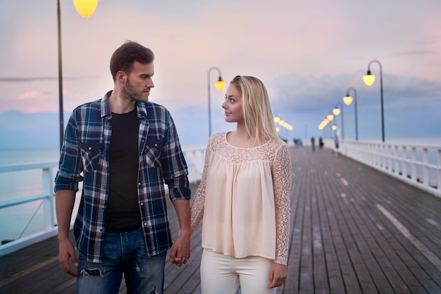 Loving couple during the romantic walk on the pier