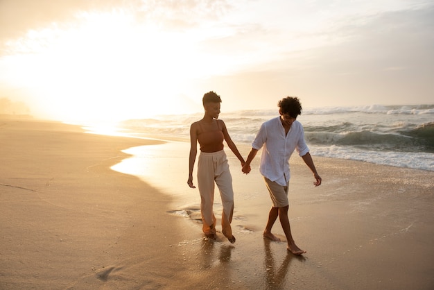 Loving couple showing affection on the beach near the ocean