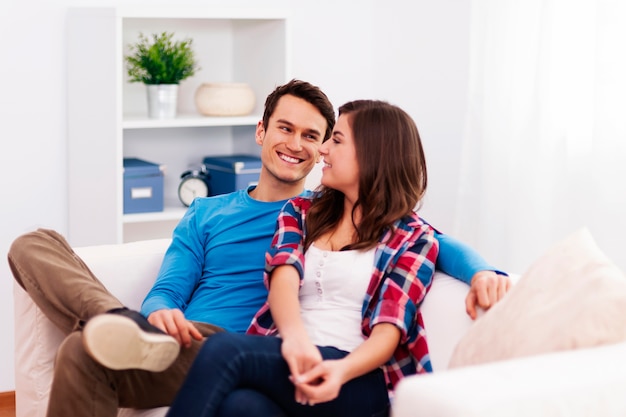 Loving couple sitting in living room