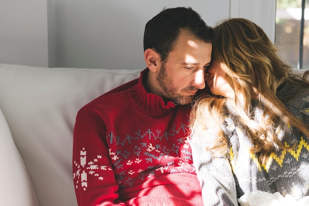 Free photo loving couple sitting on sofa