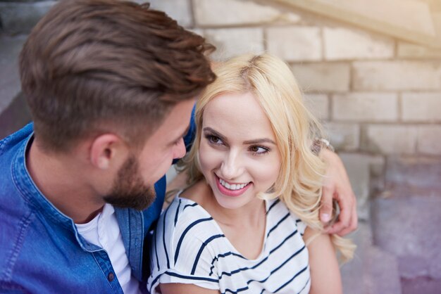 Free photo loving couple sitting at the stairs